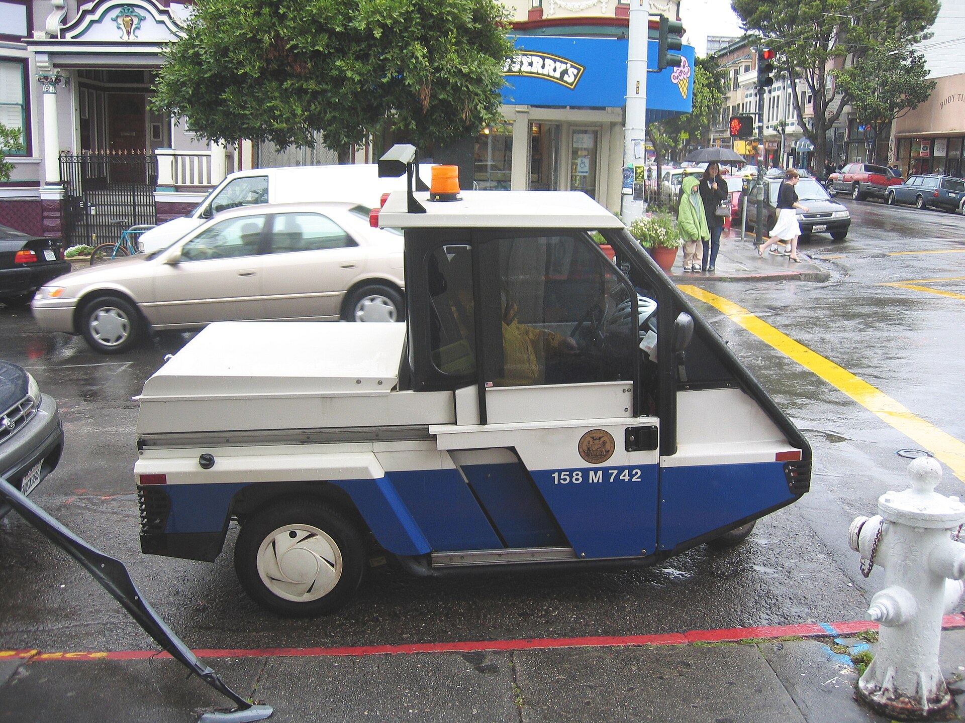 A compact parking enforcement vehicle in an urban neighborhood
