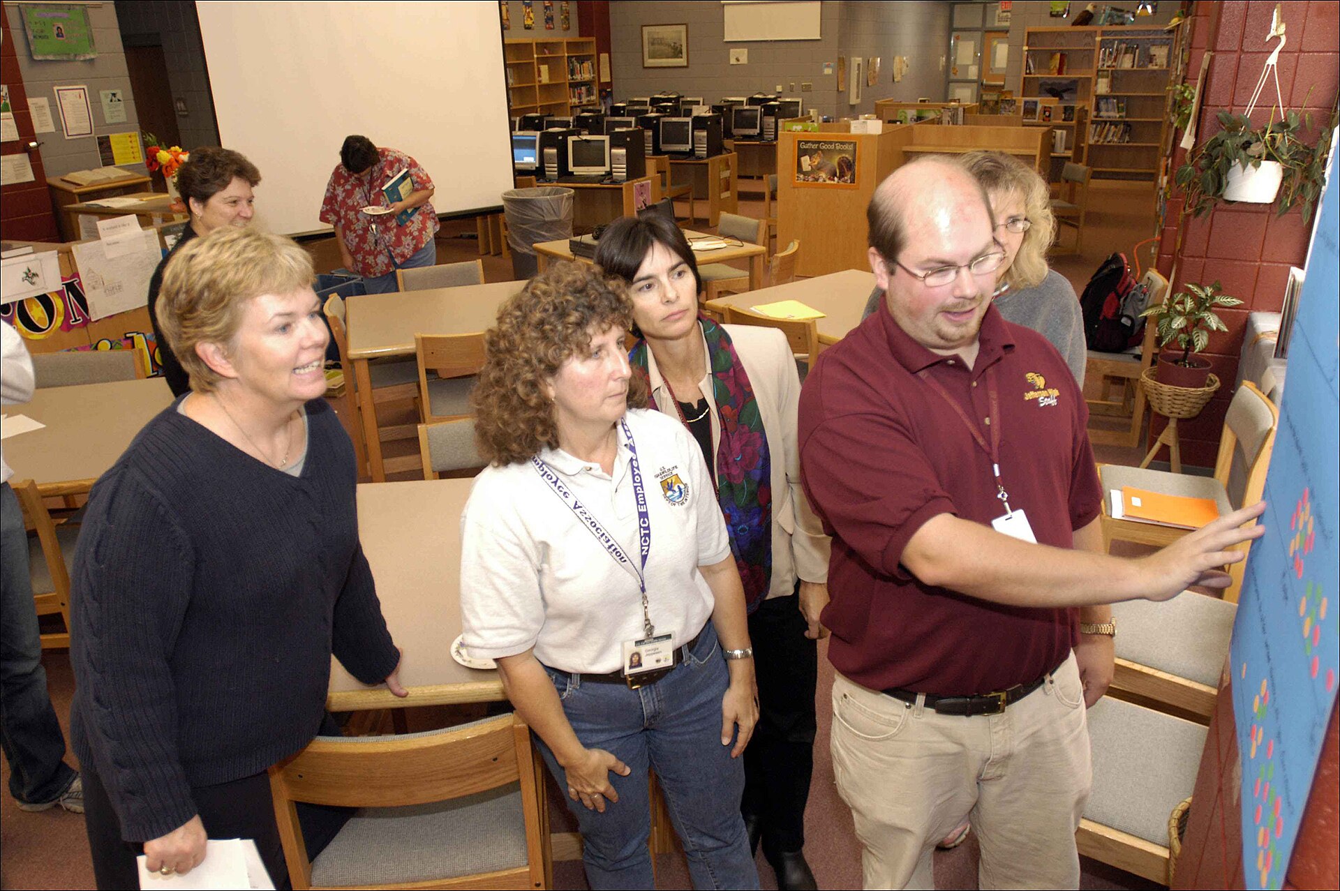 People collaborating around a chart during a project workshop